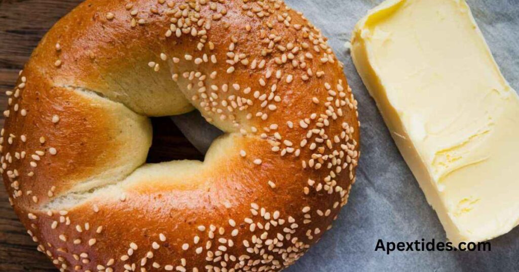 A toasted bagel topped with sesame seeds and butter, embodying bagelicious homonym hilarity in a delightful breakfast treat.