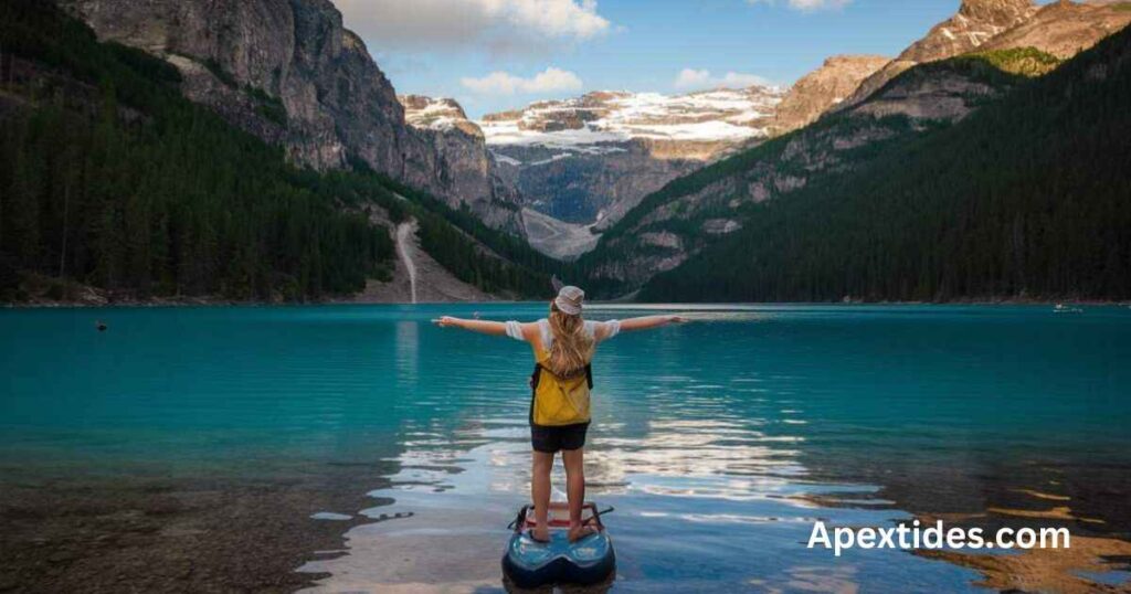 A woman on a paddle board at a mountain lake, embodying fun-lake-puns-to-make-a-splash in a serene outdoor setting.